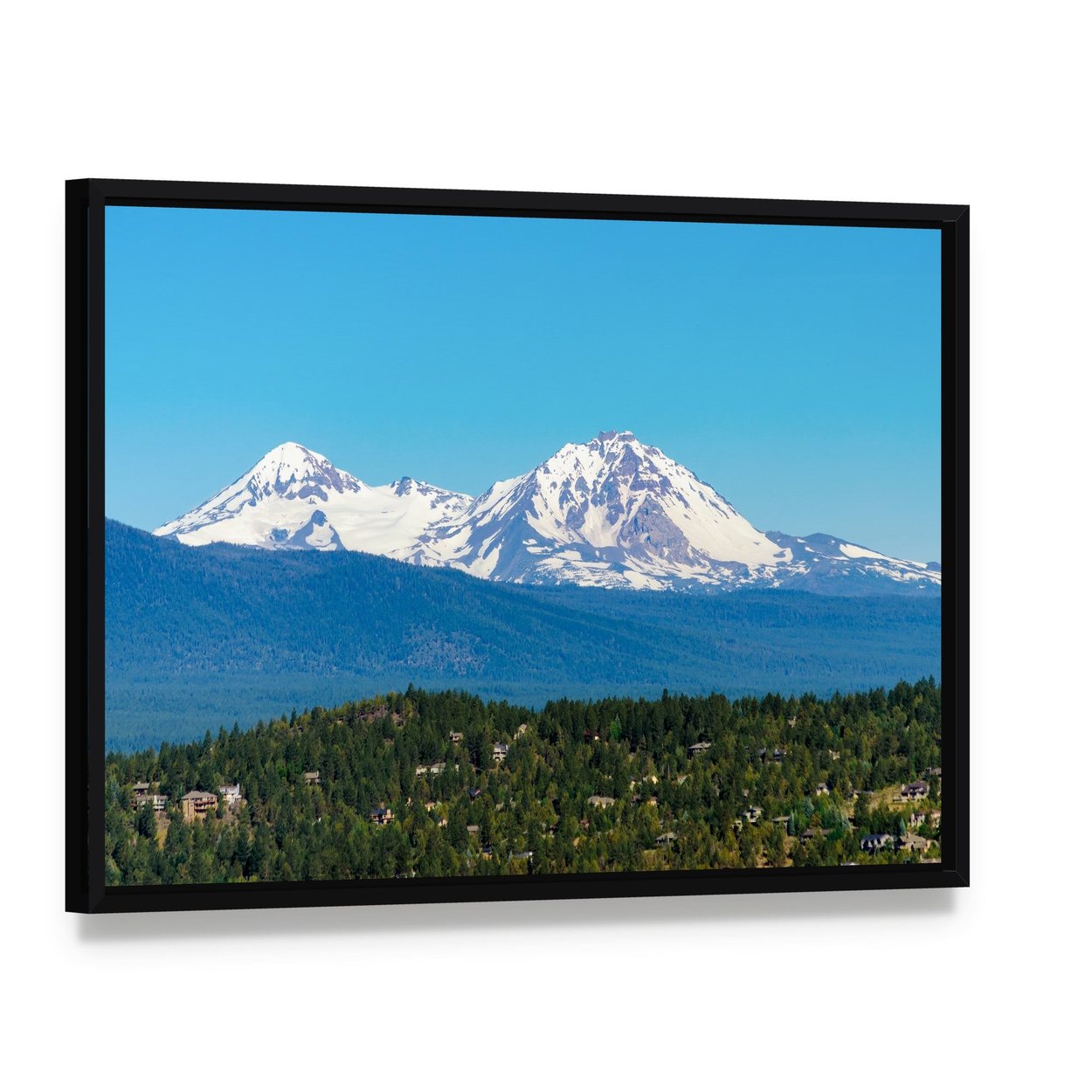 Snow Covered Three Sisters Mountains Canvas Wall Art, framed canvas in a black floater frame, angled product view