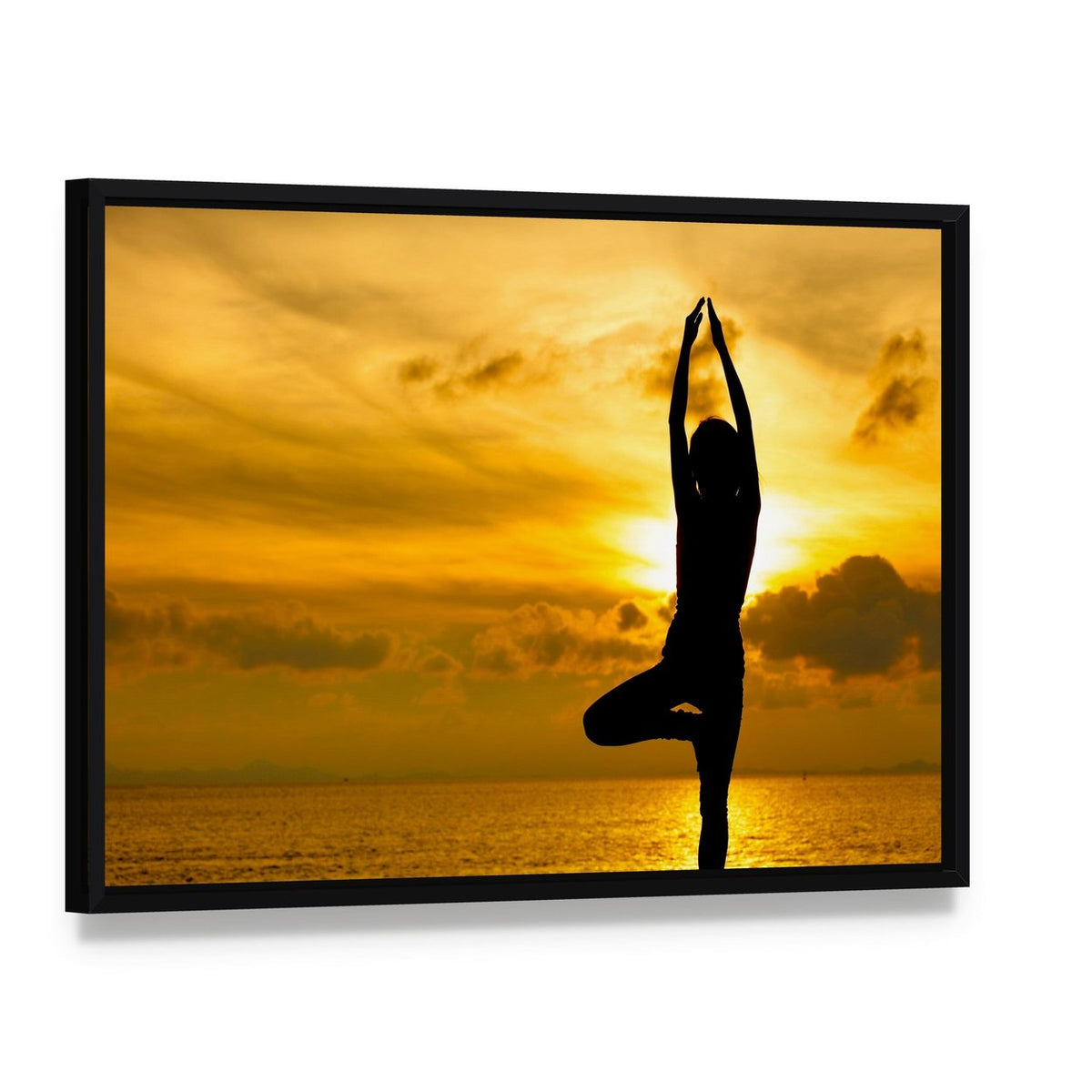 Silhouette of Yoga Woman in Sunset Canvas Wall Art, framed canvas in a black floater frame, angled product view