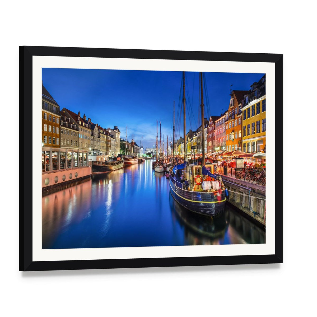 Vibrant Nyhavn Canal Scene at Night Canvas Wall Art, framed print with white mat and black frame, angled product view