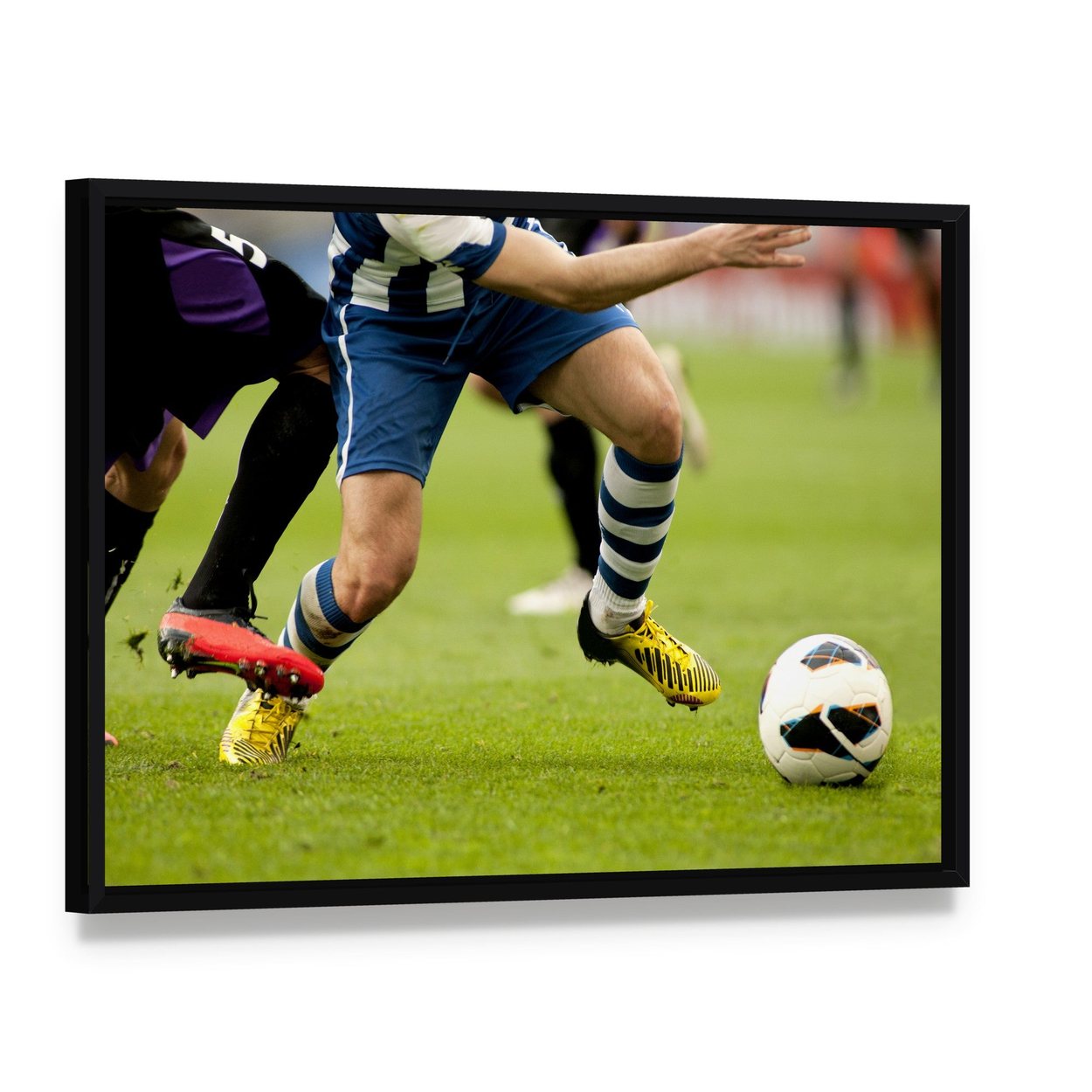 Legs of Two Soccer Players Canvas Wall Art, framed canvas in a black floater frame, angled product view
