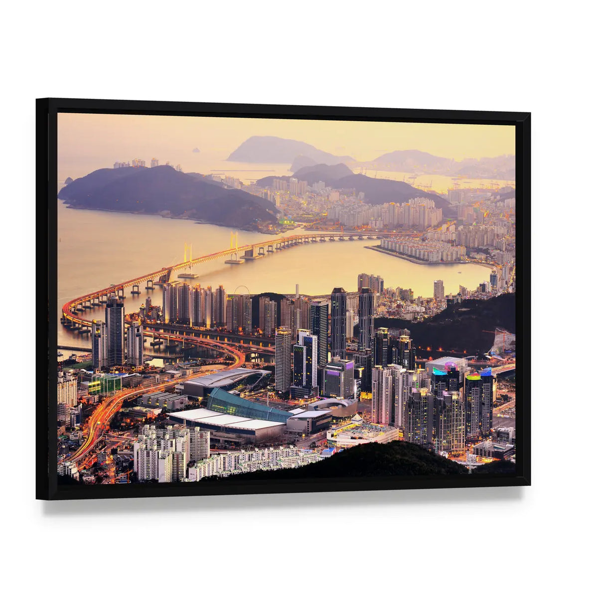 Coastal City Skyline at Golden Dusk Canvas Wall Art, framed canvas in a black floater frame, angled product view