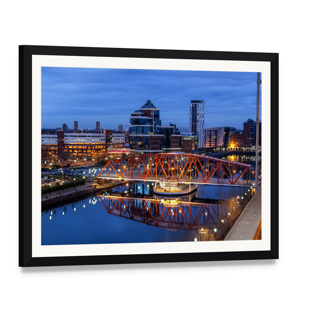 Salford Quays Skyline with Illuminated Bridge Canvas Wall Art, framed print with white mat and black frame, angled product view
