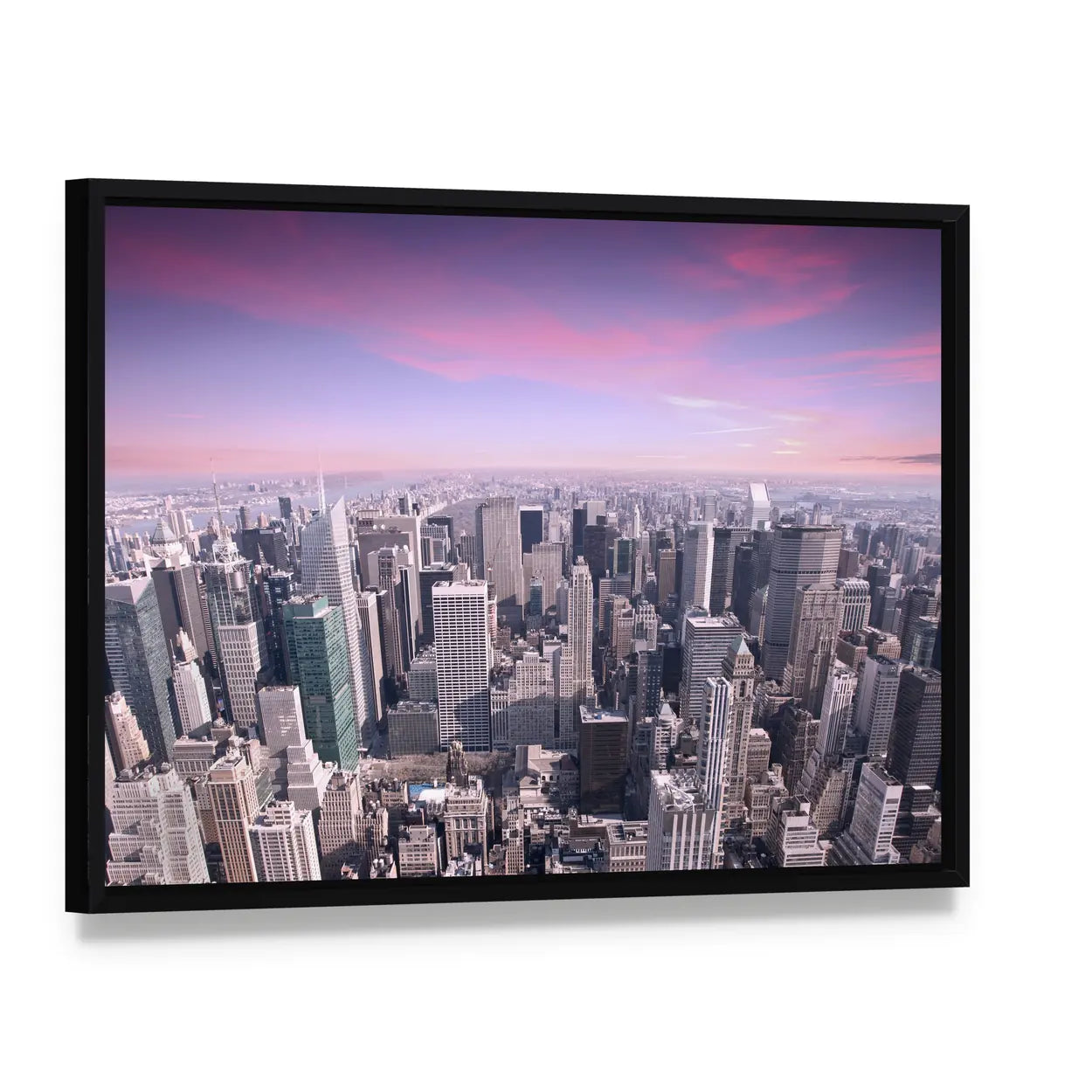 New York City Skyline at Sunset Canvas Wall Art, framed canvas in a black floater frame, angled product view