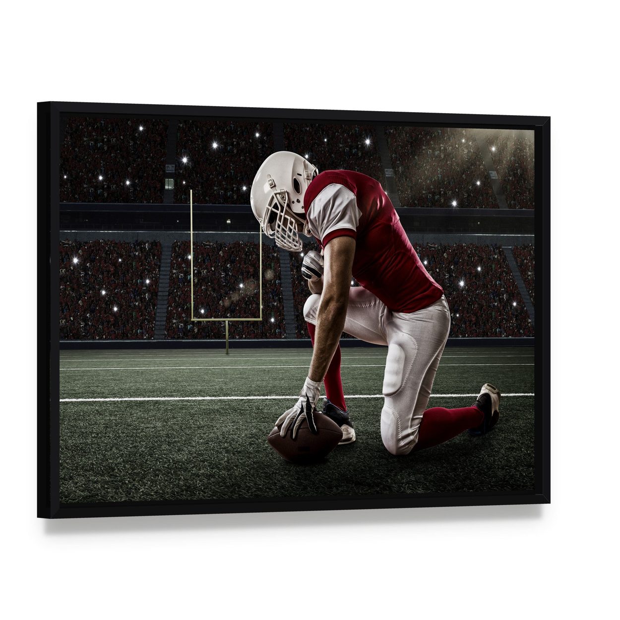 Football Player on His Knees Canvas Wall Art, framed canvas in a black floater frame, angled product view