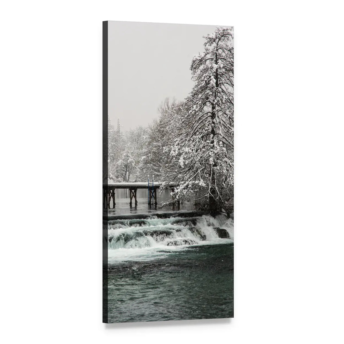 Snowy Footbridge Over Dark Teal River Vertical Canvas Wall Art, 1 panel 1 Vertical layout gallery wrapped canvas set, angled product view