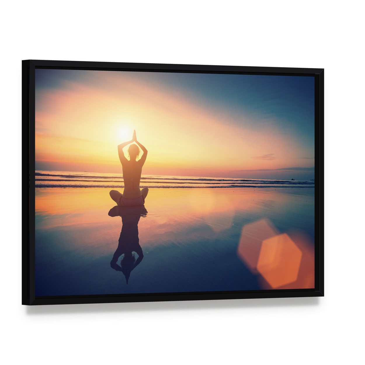Yoga Woman Sitting in Lotus Pose on the Beach Canvas Wall Art, framed canvas in a black floater frame, angled product view