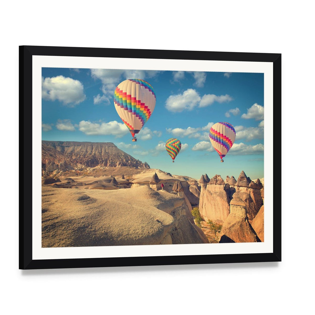 Hot Air Balloons Over Cappadocia Canvas Wall Art, framed print with white mat and black frame, angled product view