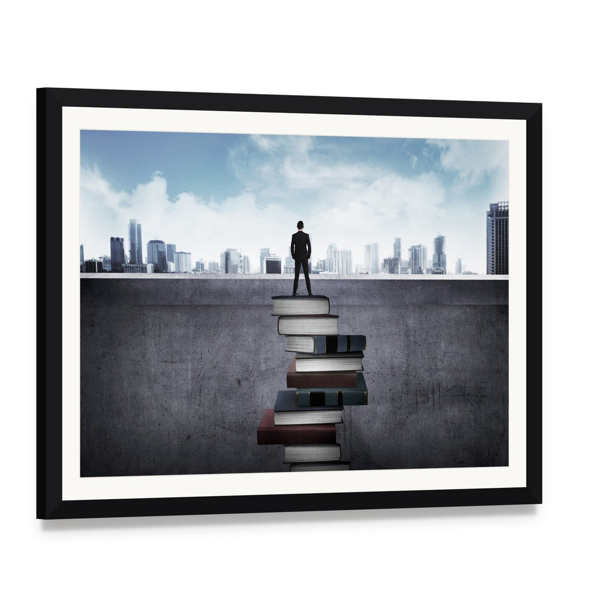 Man Standing on Books Over Cityscape Canvas Wall Art, framed print with white mat and black frame, angled product view