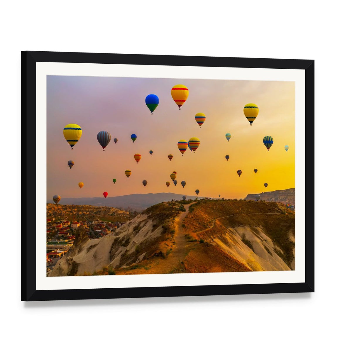 Hot Air Balloons Over a Vast Valley Canvas Wall Art, framed print with white mat and black frame, angled product view