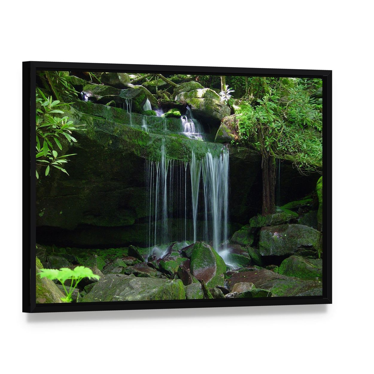 Waterfall Flows Over Moss-covered Rocks Canvas Wall Art, framed canvas in a black floater frame, angled product view