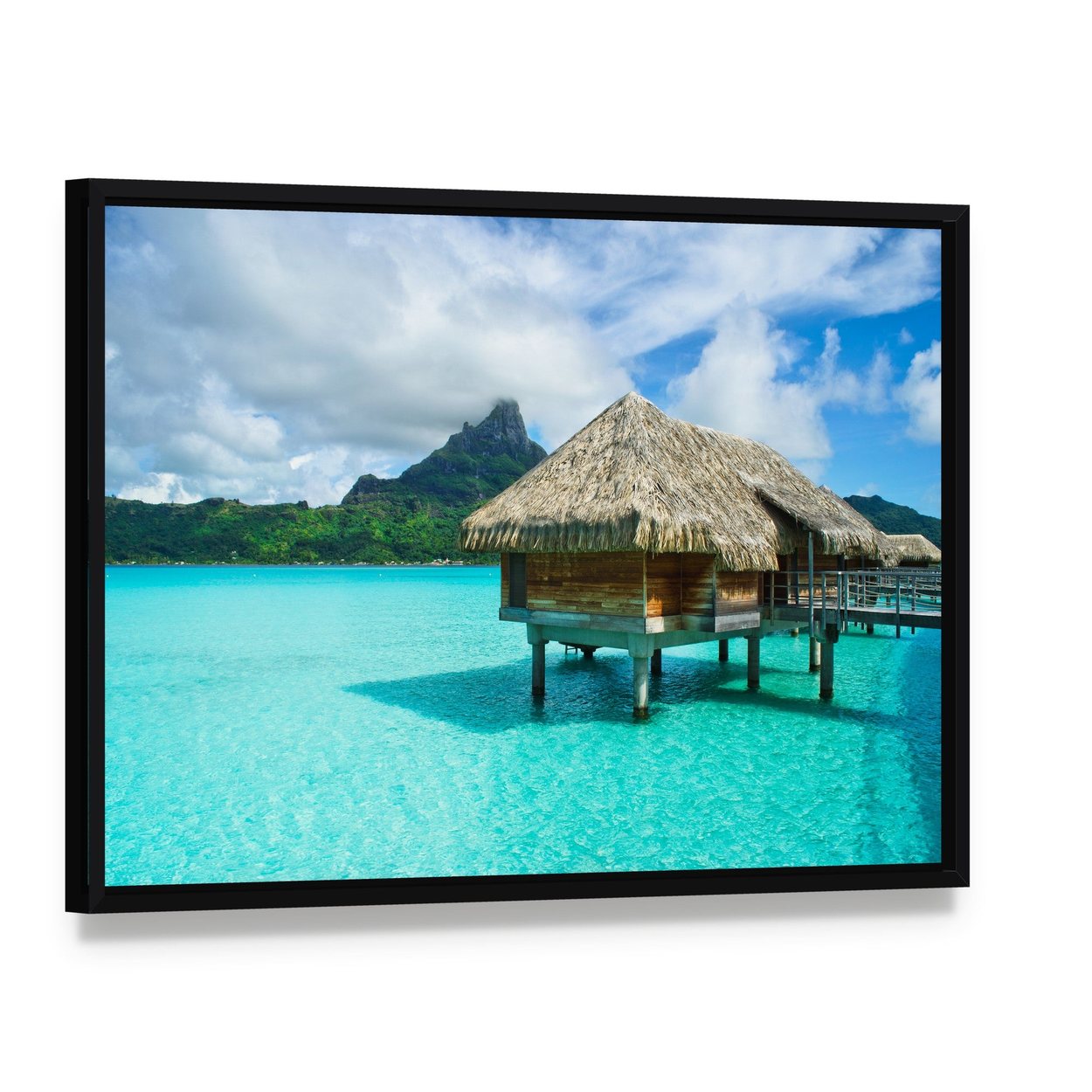Thatched Roof Bungalow Over Turquoise Water Canvas Wall Art, framed canvas in a black floater frame, angled product view