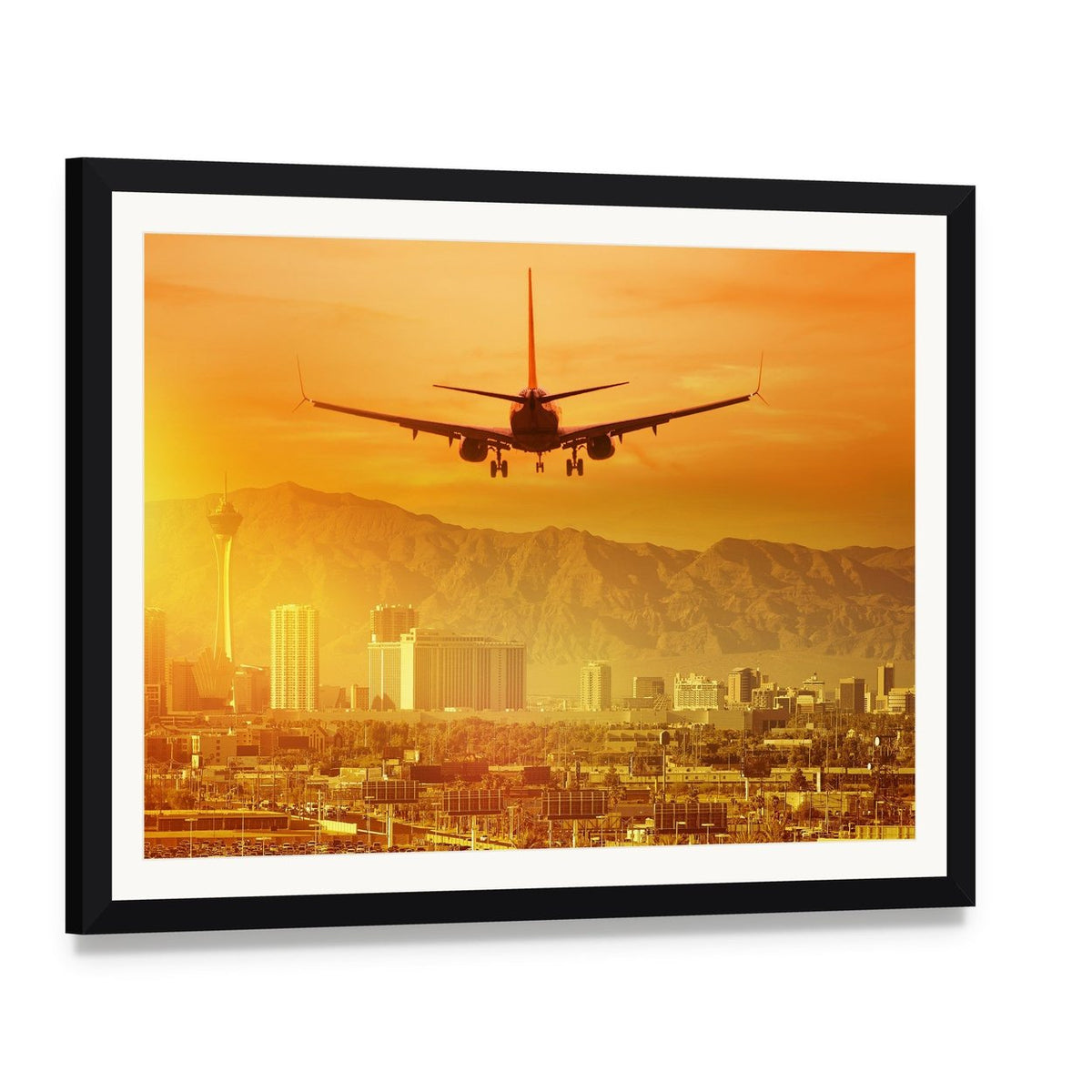 Airplane Flying Above City Canvas Wall Art, framed print with white mat and black frame, angled product view