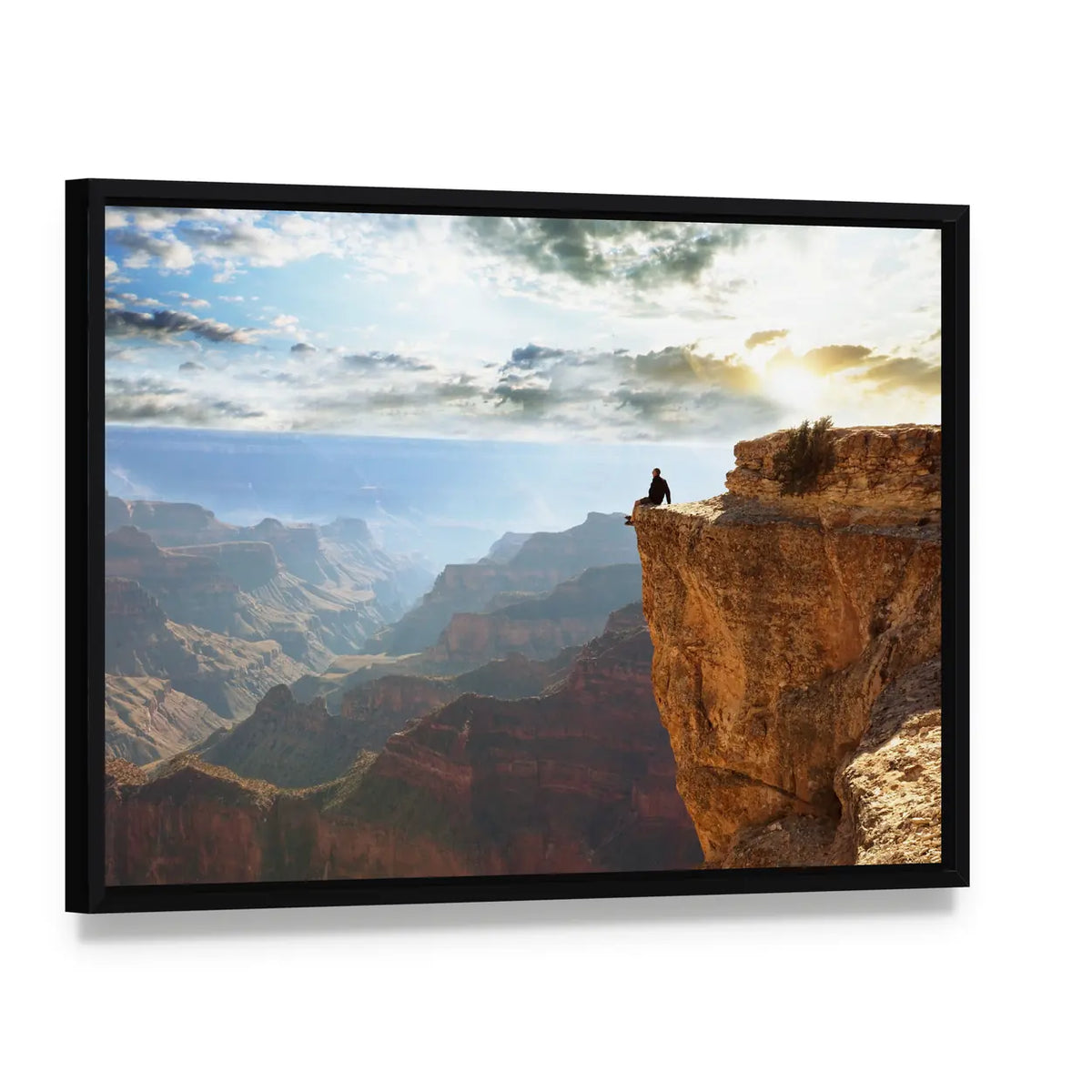 Man Sitting on Grand Canyon Canvas Wall Art, framed canvas in a black floater frame, angled product view