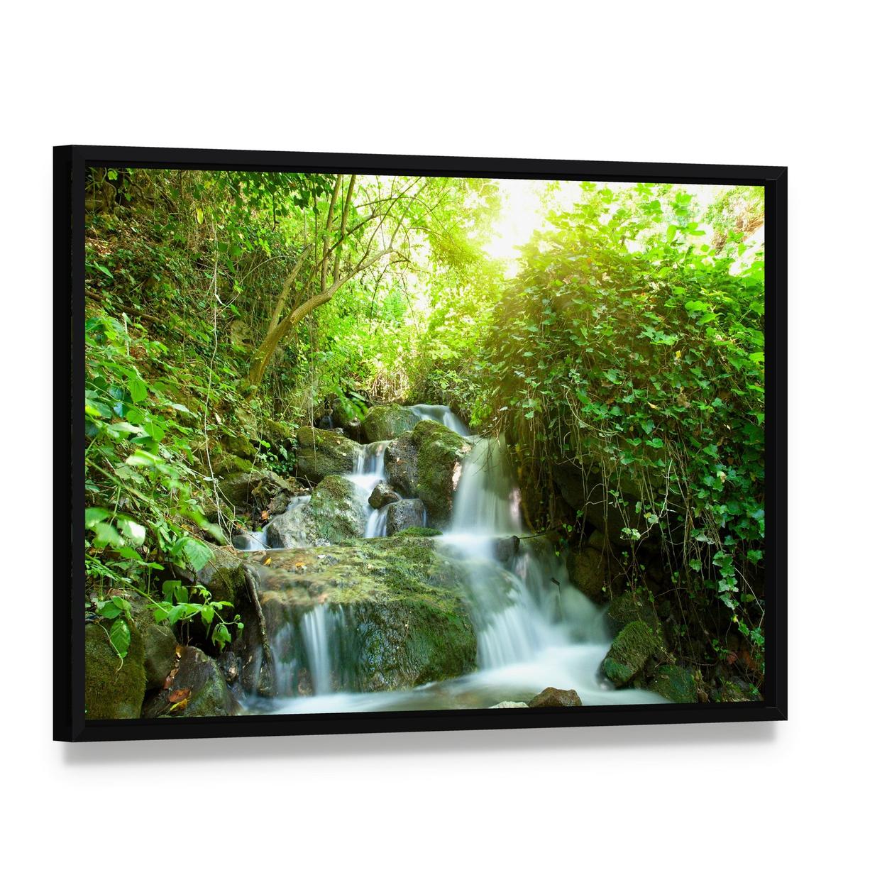 Waterfall in Small Forest Canvas Wall Art, framed canvas in a black floater frame, angled product view