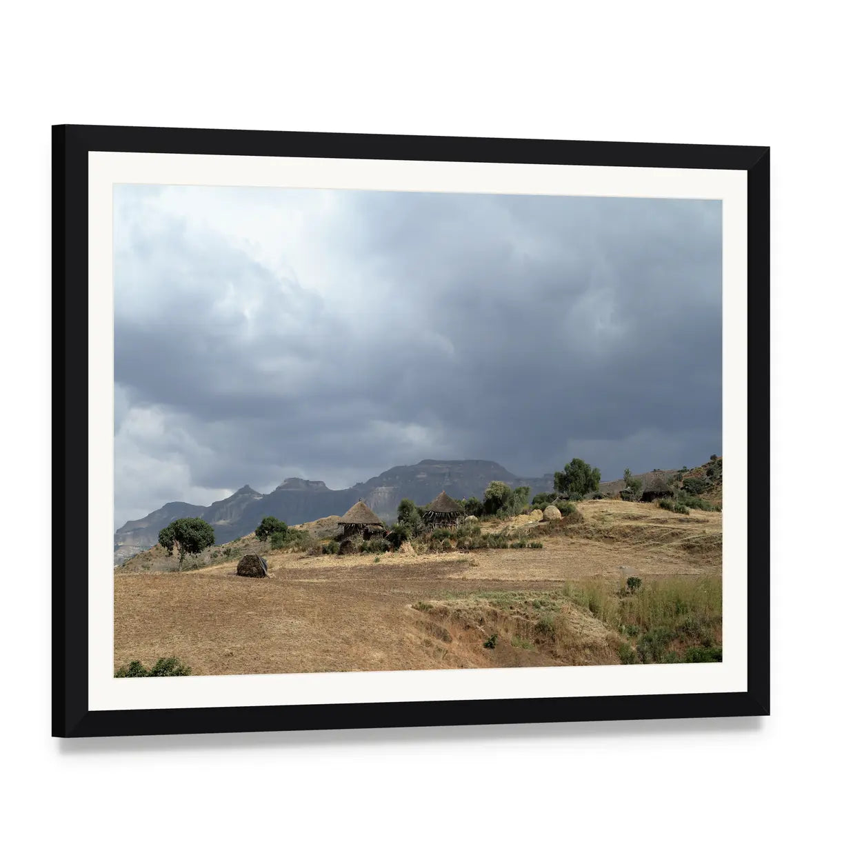Thatched Huts in Rural Africa Canvas Wall Art, framed print with white mat and black frame, angled product view