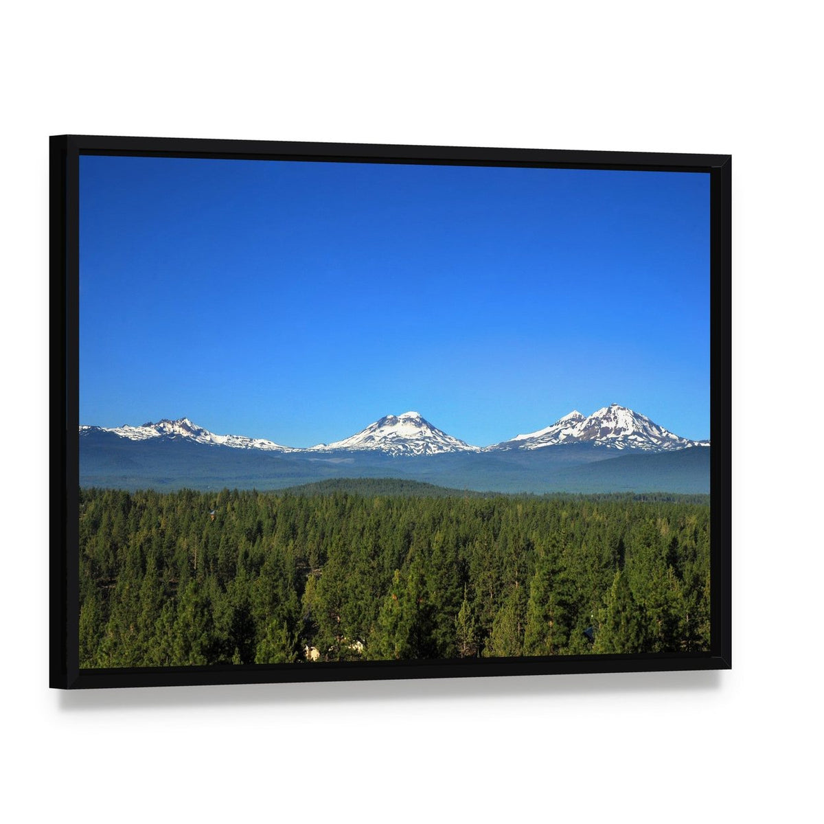 Three Sisters Mountains Oregon Canvas Wall Art, framed canvas in a black floater frame, angled product view