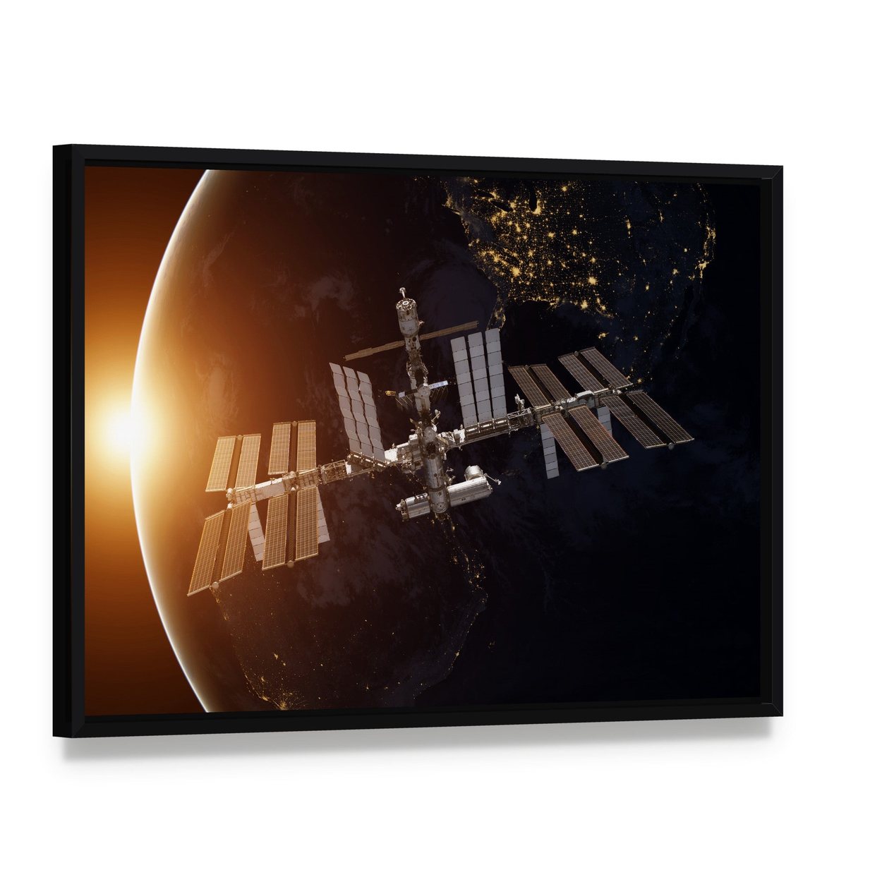 International Space Station Over Planet Earth Canvas Wall Art, framed canvas in a black floater frame, angled product view