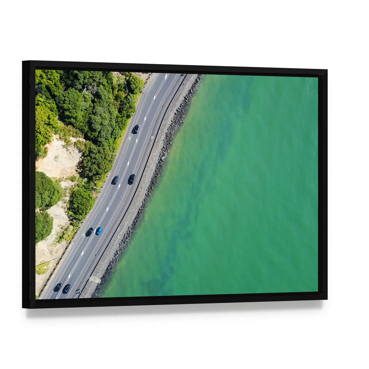 Coastal Road in Auckland Canvas Wall Art, framed canvas in a black floater frame, angled product view