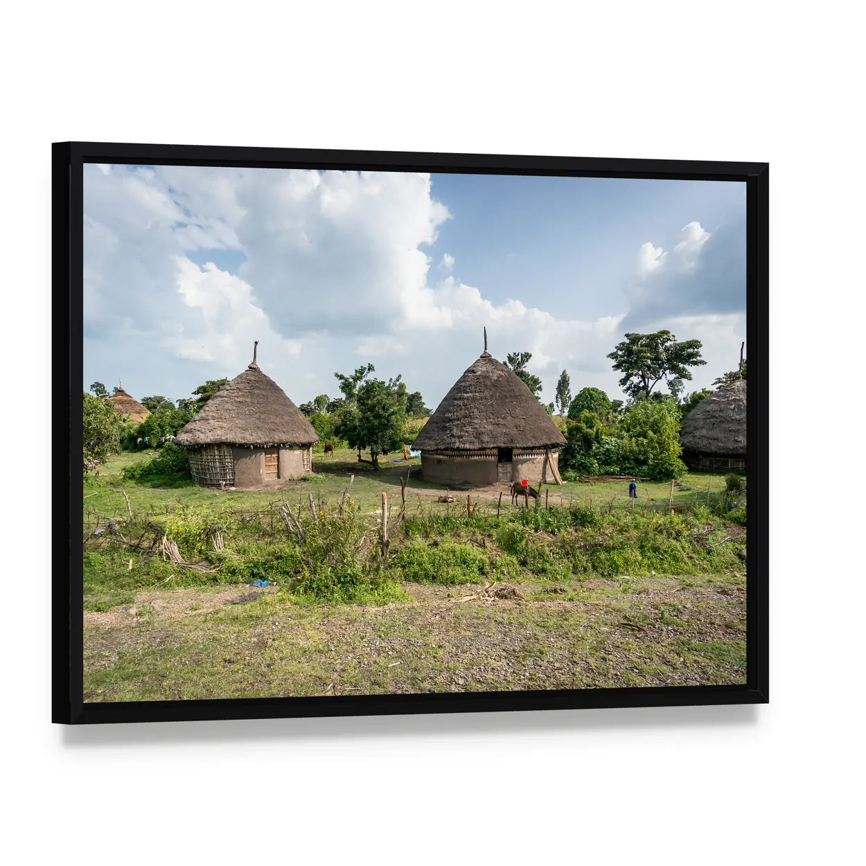 Omo Valley Straw Huts Canvas Wall Art, framed canvas in a black floater frame, angled product view