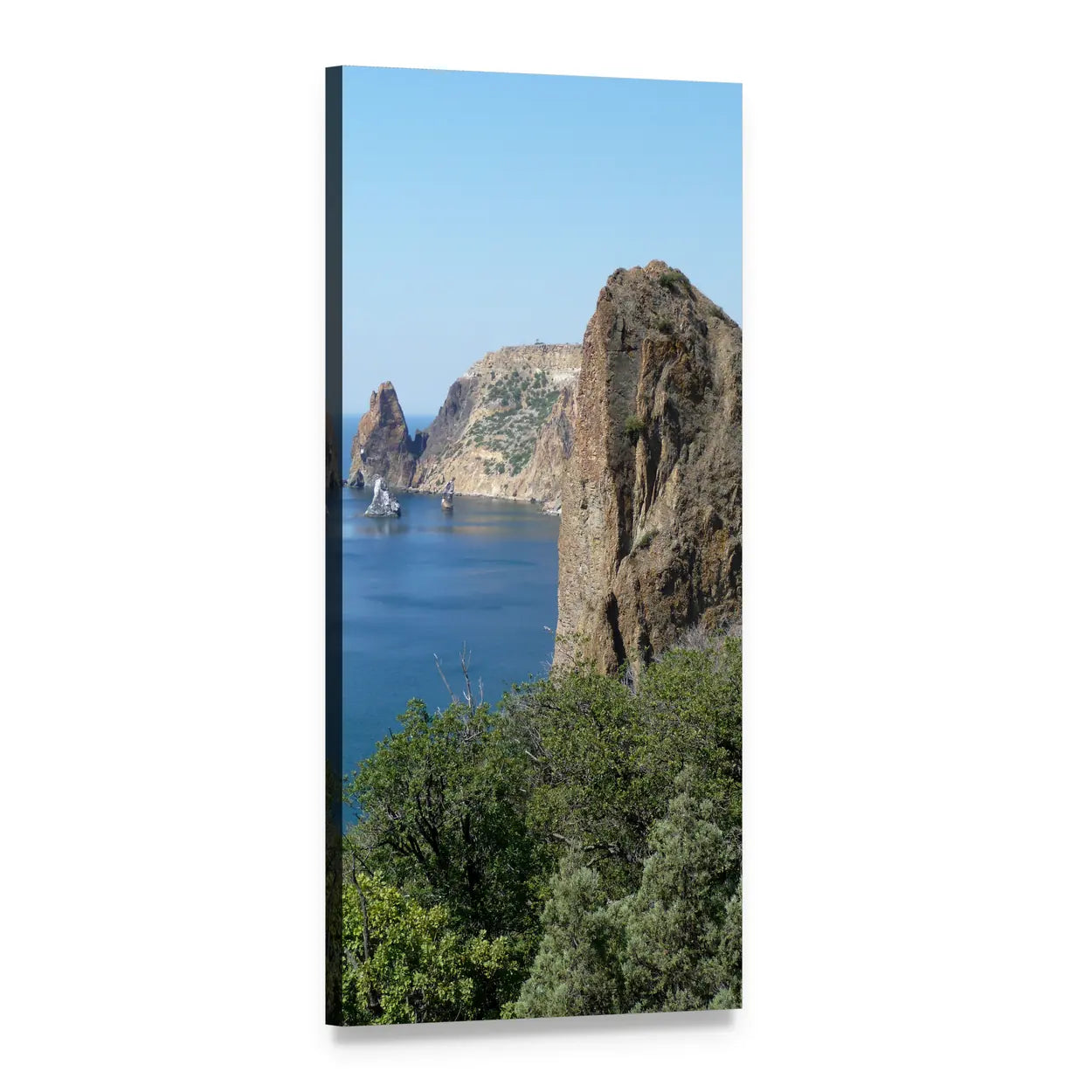 Coastal Cliffs with Rock Spire Over Blue Bay Vertical Canvas Wall Art, 1 panel 1 Vertical layout gallery wrapped canvas set, angled product view