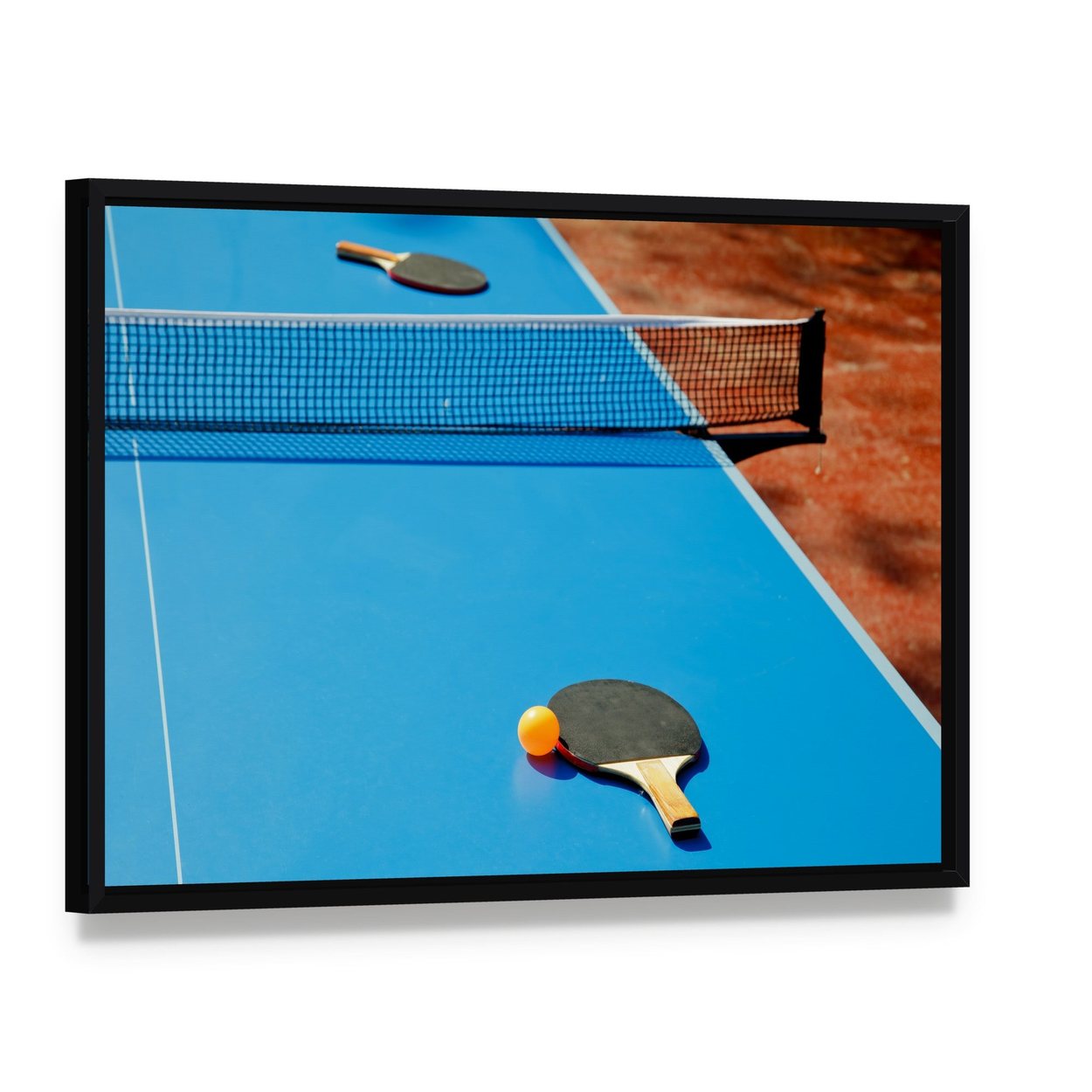 Ping Pong Ball with Paddle on Tennis Table Canvas Wall Art, framed canvas in a black floater frame, angled product view