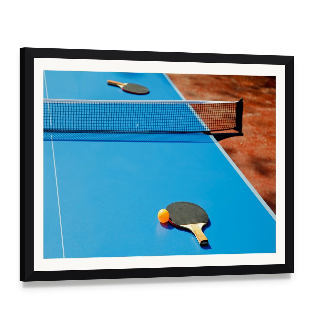 Ping Pong Ball with Paddle on Tennis Table Canvas Wall Art, framed print with white mat and black frame, angled product view