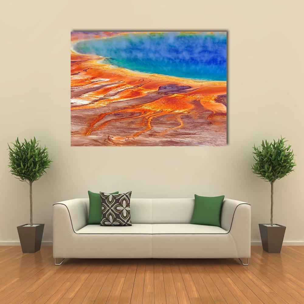 Grand Prismatic Spring Watercolor Canvas Wall Art in orange, blue and multicolor, single panel hung on a wall