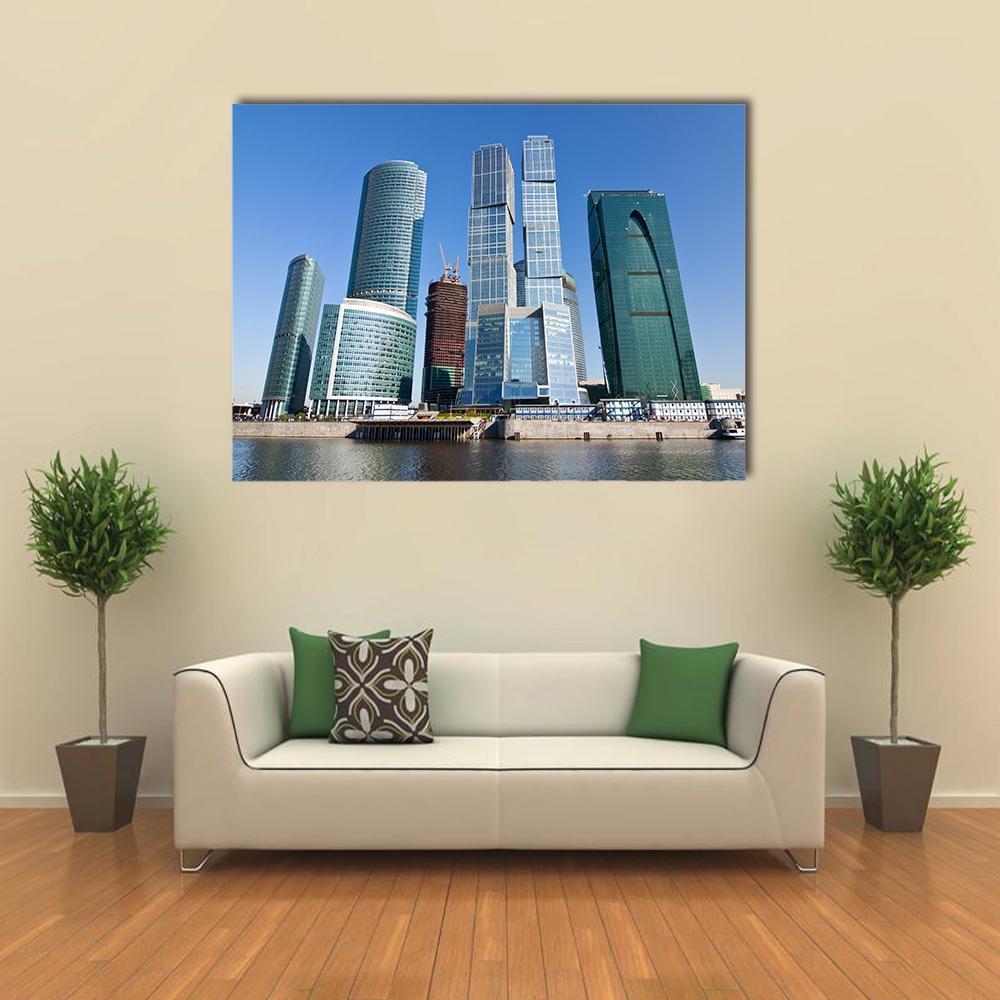 Moscow City Skyscrapers Under Blue Sky Canvas Wall Art in gray and blue, single panel hung on a wall