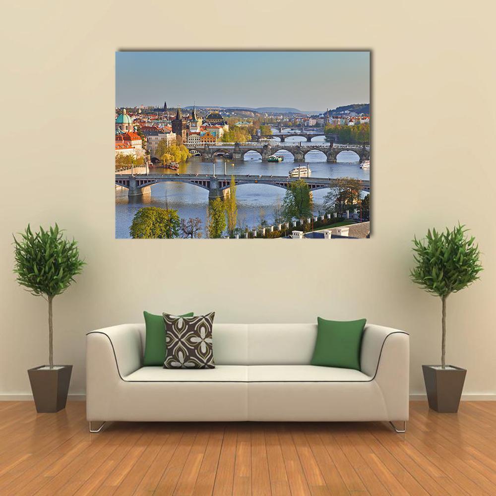 Prague River Bridges at Sunset Canvas Wall Art in gray, orange and blue, single panel hung on a wall