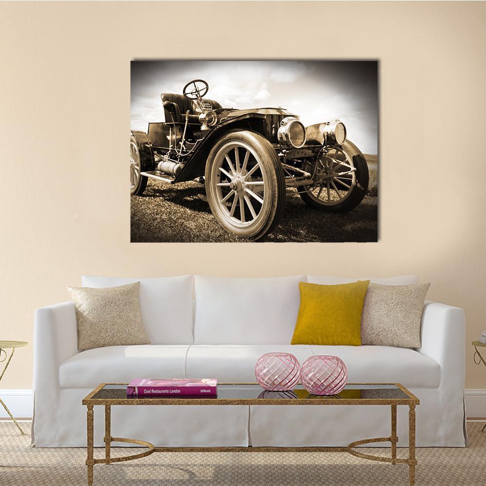 Vintage Car Front Wheel Detail Canvas Wall Art in black, beige and brown, single panel hung on a wall