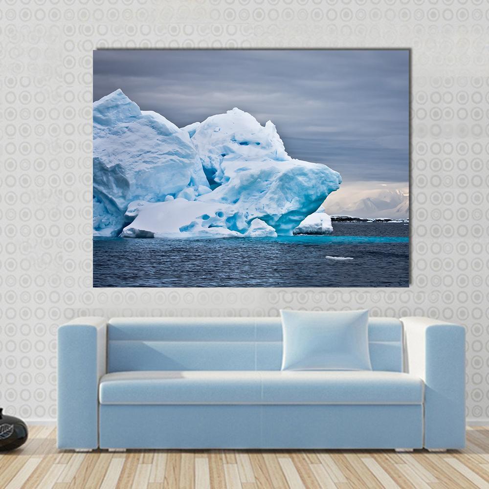Antarctic Iceberg Under Dark Sky Canvas Wall Art in white, gray and blue, single panel hung on a wall