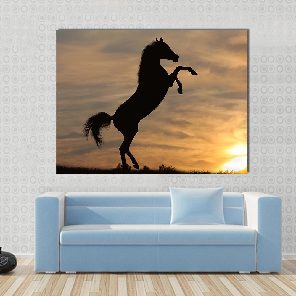 Rearing Horse Silhouette at Sunset Canvas Wall Art in black, orange and yellow, single panel hung on a wall