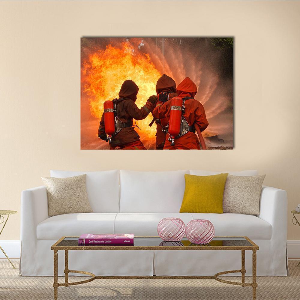 Three Firefighters Facing Intense Blaze Canvas Wall Art in black, red and orange, single panel hung on a wall