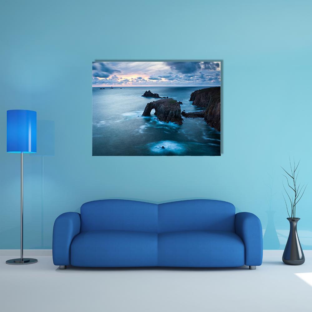 Stormy Sunset Over Sea Arch Canvas Wall Art in gray, orange and blue, single panel hung on a wall
