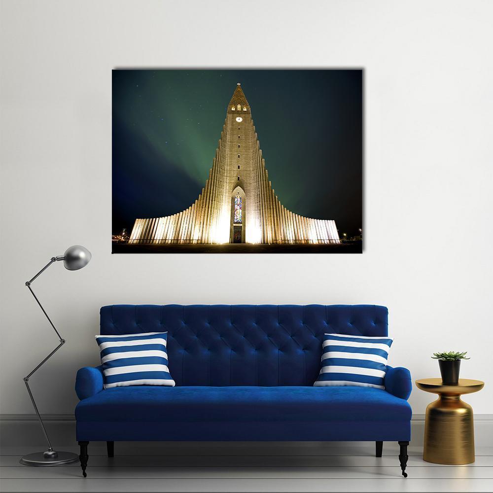 Hallgrímskirkja in Reykjavik Under Northern Lights Canvas Wall Art in black, yellow and green, single panel hung on a wall