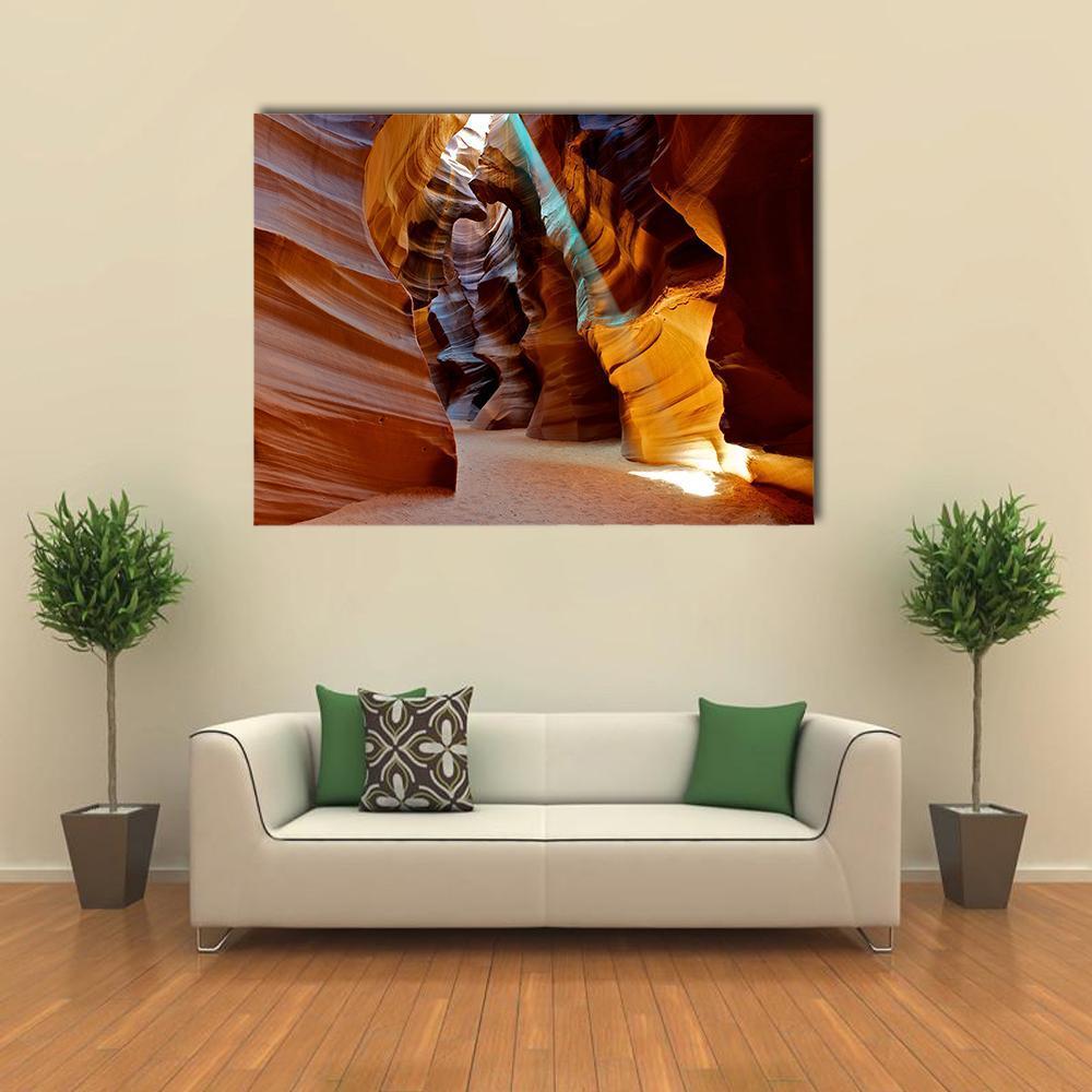 Sun Beam Through Slot Canyon Canvas Wall Art in brown, orange and yellow, single panel hung on a wall