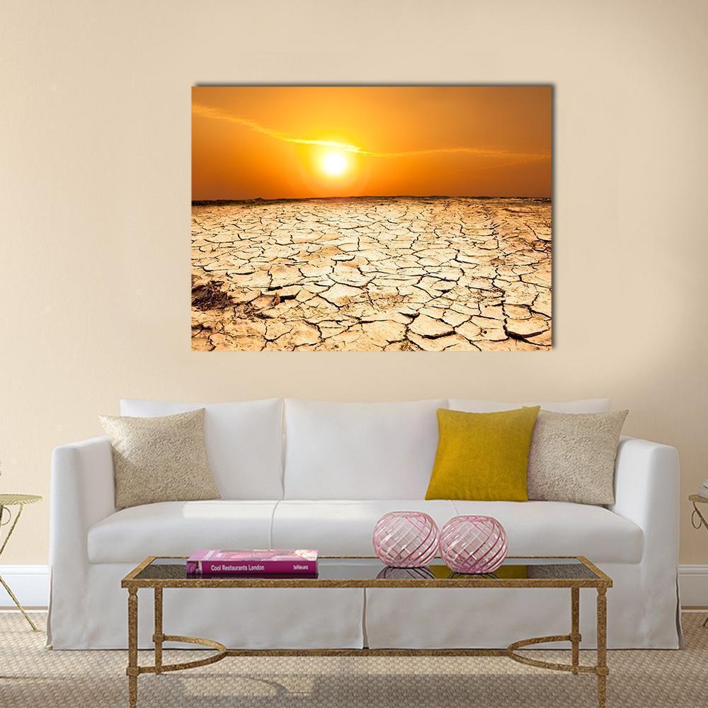 Cracked Earth at Sunset Canvas Wall Art in brown, orange and yellow, single panel hung on a wall