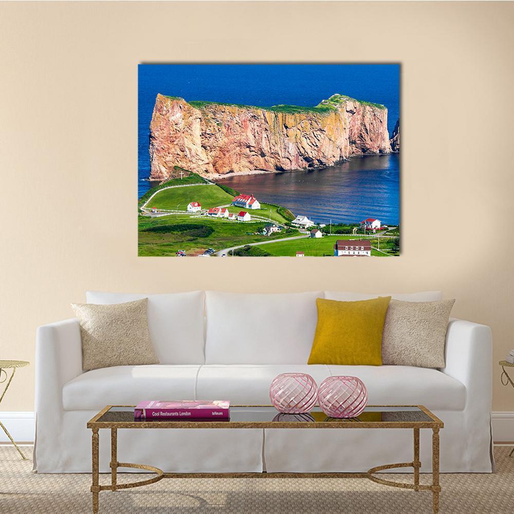 Perce Rock with Red-roof Village Canvas Wall Art in brown, green and blue, single panel hung on a wall