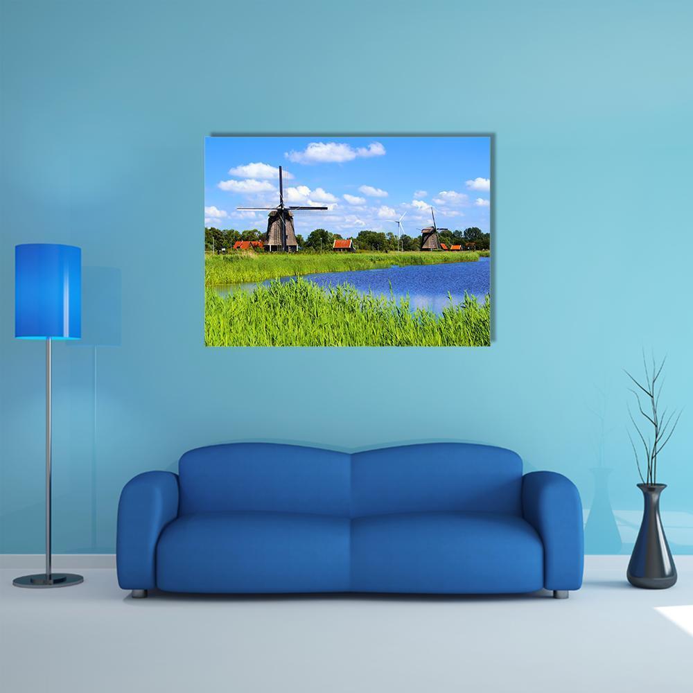 Windmills Along a Canal Canvas Wall Art in white, green and blue, single panel hung on a wall