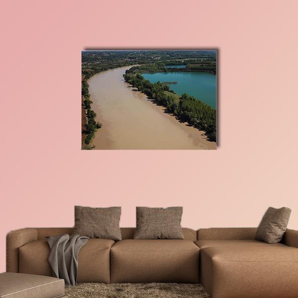 Aerial View of Turquoise Lake and River Canvas Wall Art in brown, green and blue, single panel hung on a wall