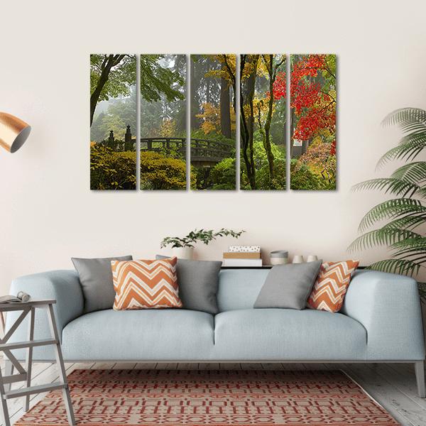 Arched Wooden Bridge in Misty Japanese Garden Canvas Wall Art in brown, yellow and green, hung on a wall