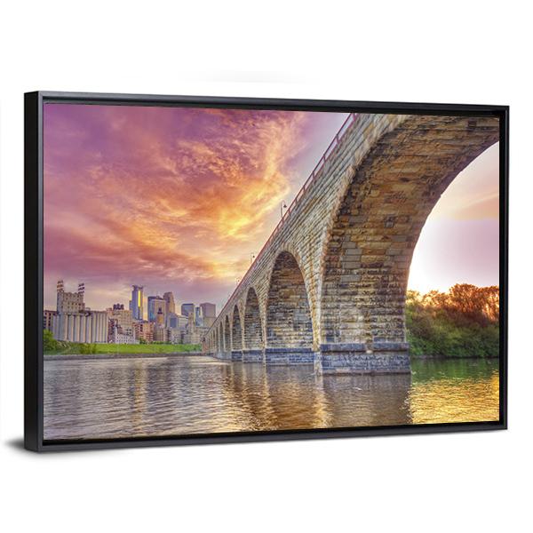 Minneapolis Arch Bridge at Sunset Canvas Wall Art in brown, orange and purple, framed canvas, product view on a white background
