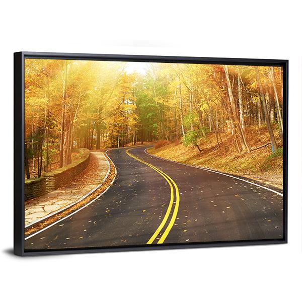 Autumn Road Through Sunlit Trees Canvas Wall Art in black, orange and yellow, framed canvas, product view on a white background
