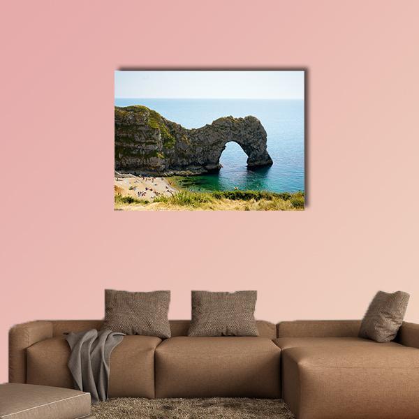 Durdle Door Limestone Arch Over Turquoise Sea Canvas Wall Art in gray, brown and blue, single panel hung on a wall