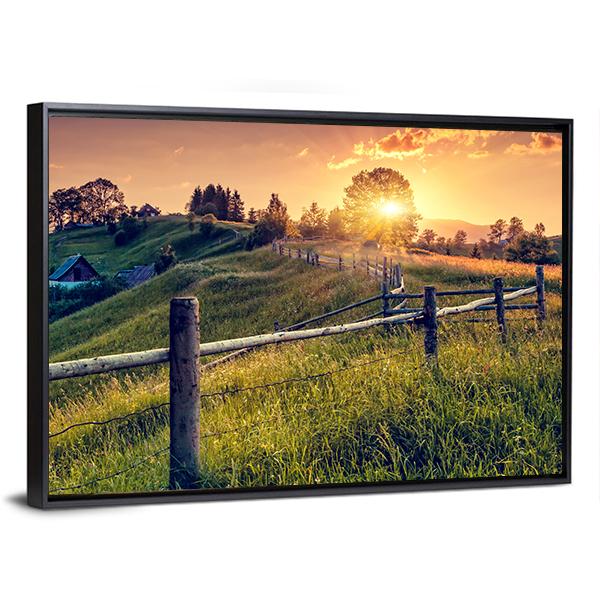 Sunset Farmhouse with Wooden Fence Canvas Wall Art in orange, yellow and green, framed canvas, product view on a white background
