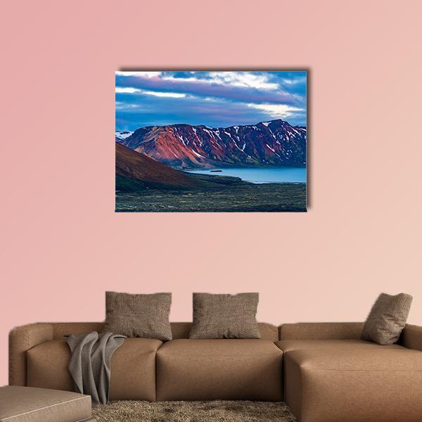Snow-patched Mountain Over Calm Lake Canvas Wall Art in brown, red and blue, single panel hung on a wall