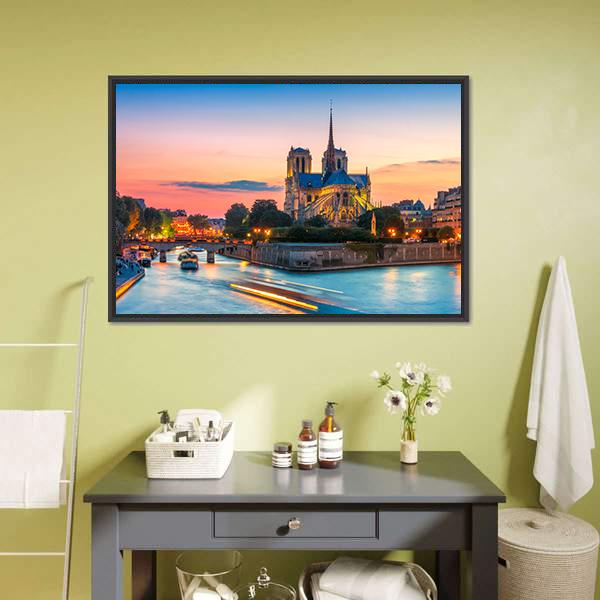 Notre-dame Cathedral at Dusk Canvas Wall Art in orange, yellow and blue, hung on a wall