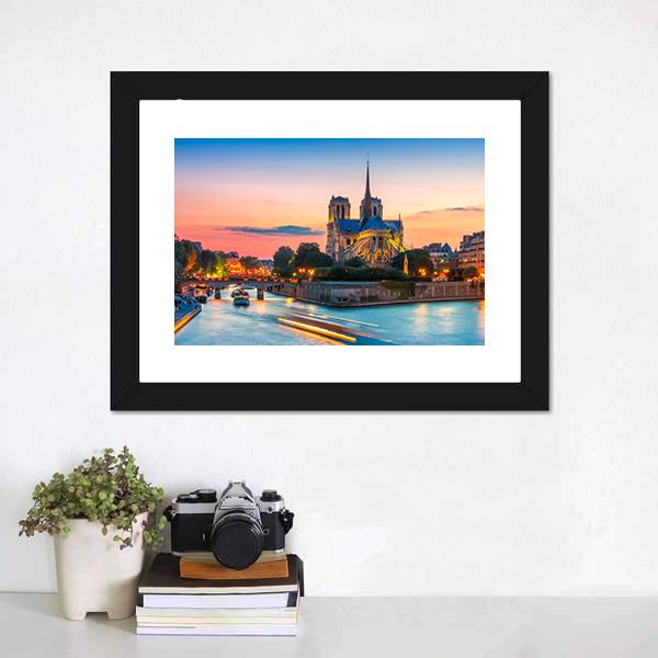 Notre-dame Cathedral at Dusk Canvas Wall Art in orange, yellow and blue, hung on a wall