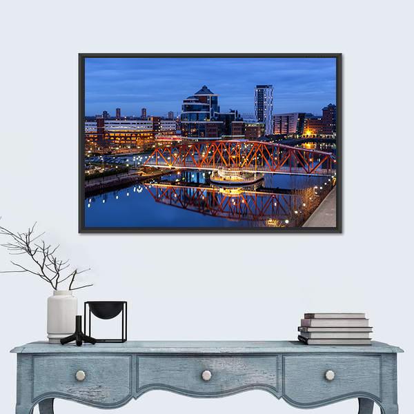 Salford Quays Skyline with Illuminated Bridge Canvas Wall Art in black, orange and blue, framed canvas, product view on a white background