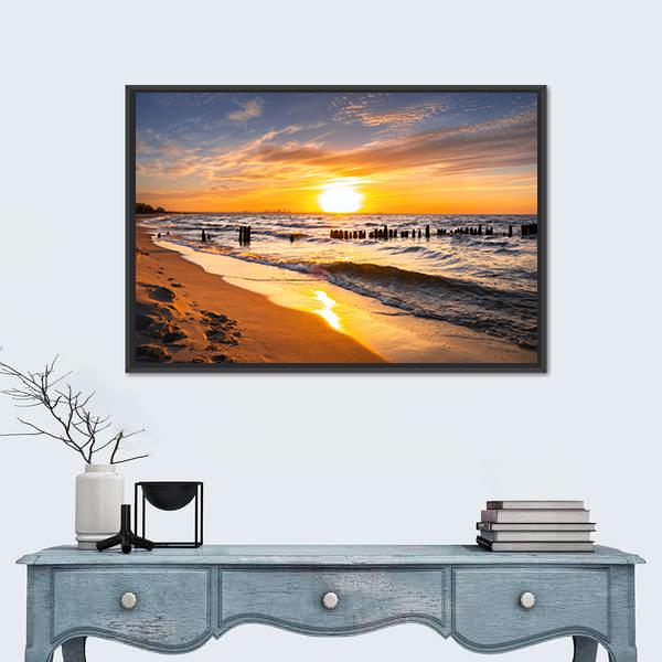Glowing Beach Sunset with Footprints Canvas Wall Art in orange, yellow and blue, framed canvas, product view on a white background
